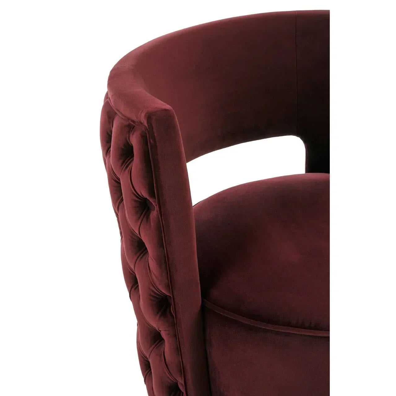 Plush velvet accent chair with burgundy tufted backrest and round seat, close-up view