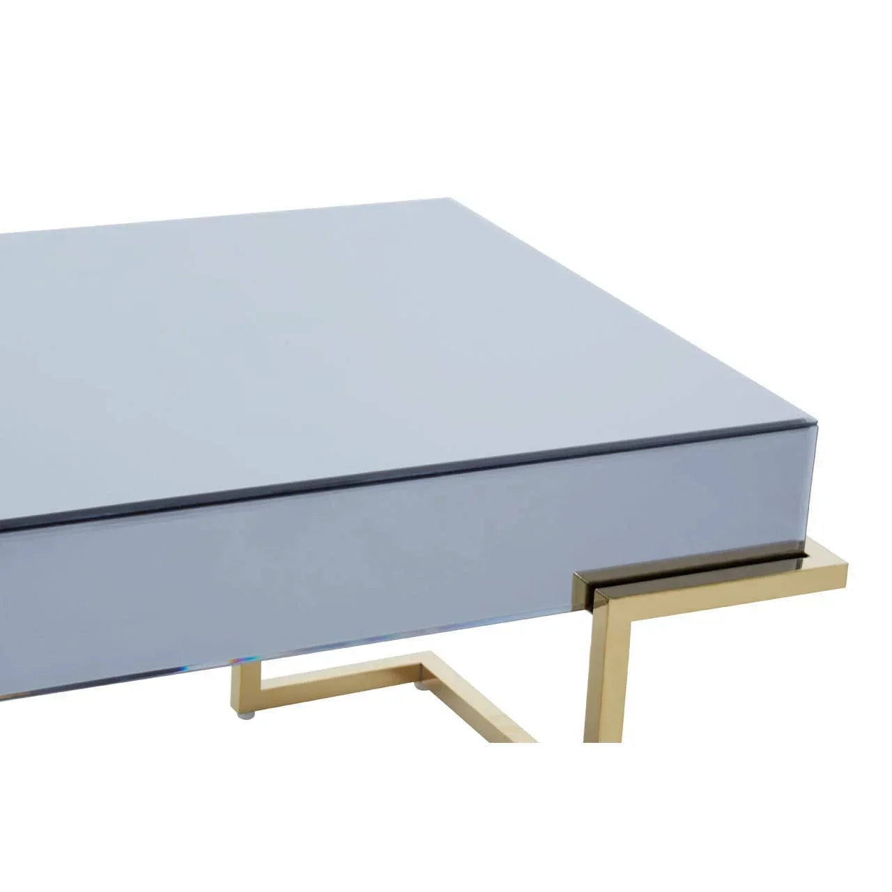 Glass top coffee table with gold metal frame, close-up of corner and leg design
