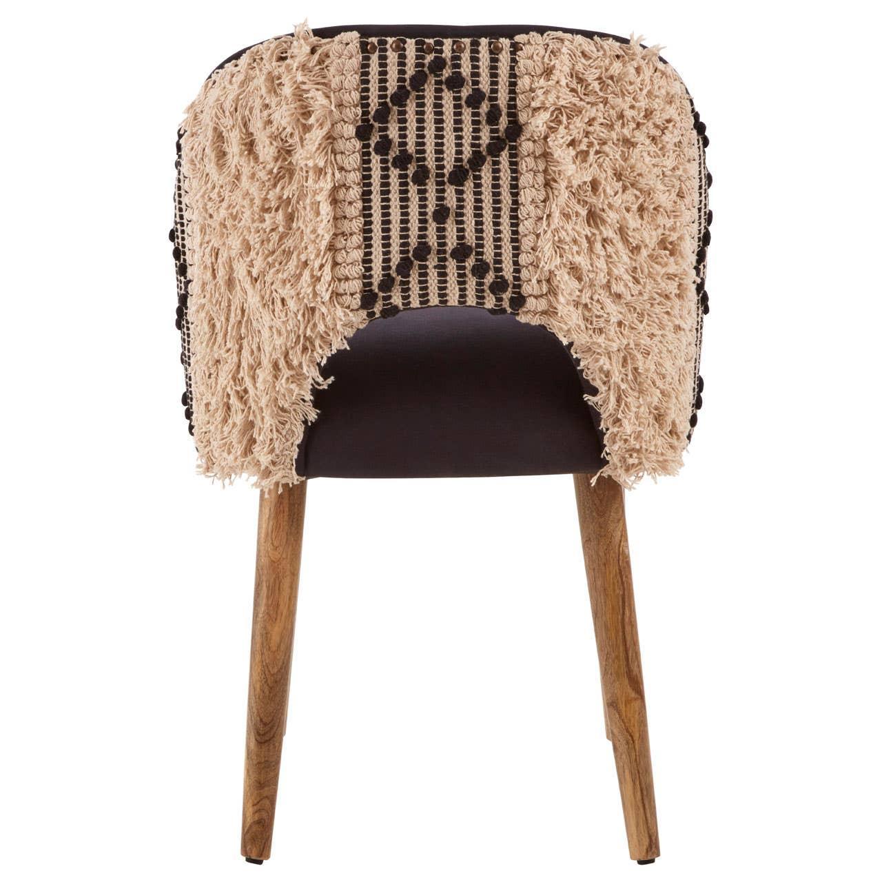 Accent chair with natural wooden legs and textured beige and black woven backrest