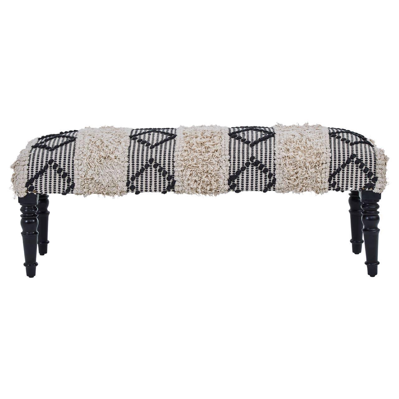 Patterned upholstered bench with black turned legs and textured cream and black fabric
