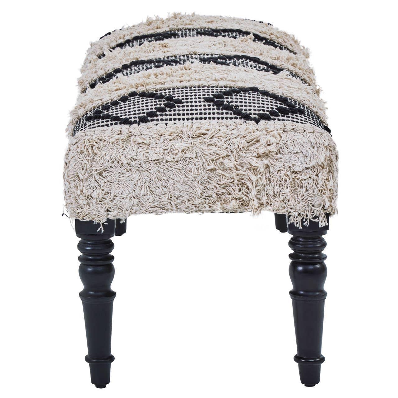 Boho style upholstered bench with textured cream fabric and black wooden legs