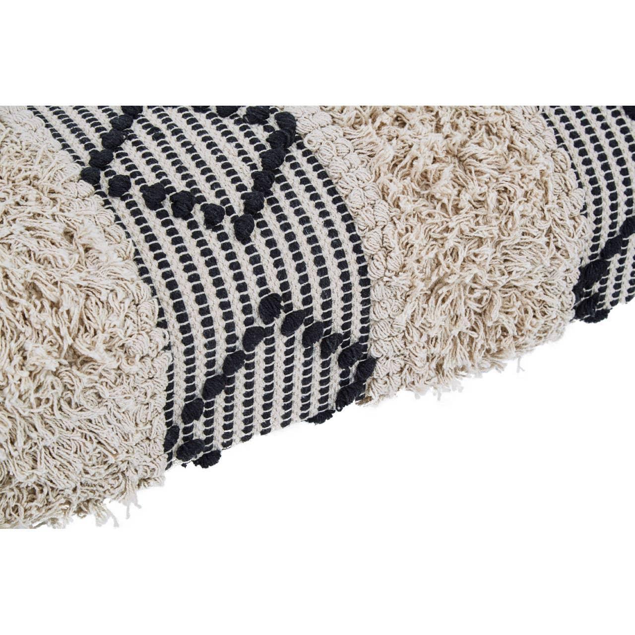 Closeup of textured cream and black patterned cushion with tufted and embroidered detail