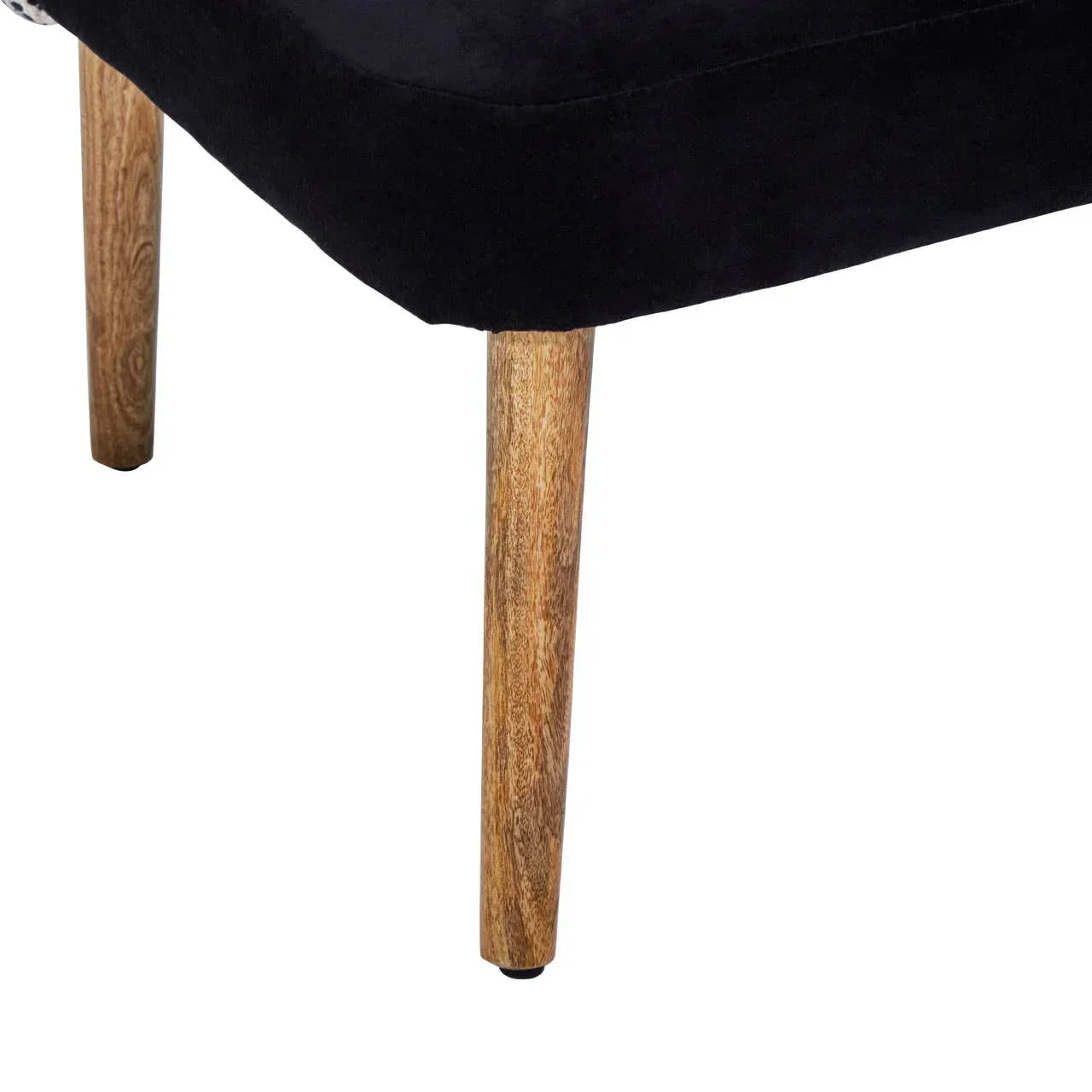 Black upholstered chair with natural wooden legs, close-up view of seat and leg detail