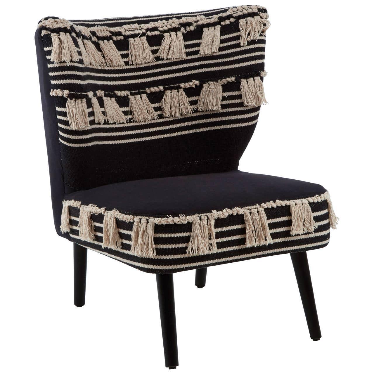 Black accent chair with cream striped woven fabric and tassel trim, angled front view
