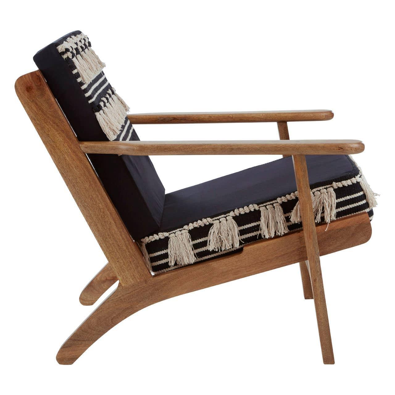 Modern wooden armchair with black cushion and fringe detail, side view