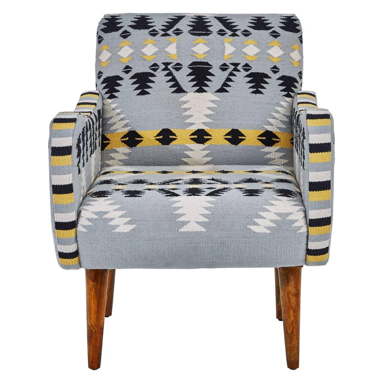 Patterned fabric accent chair with wooden legs and geometric blue, black, and yellow design