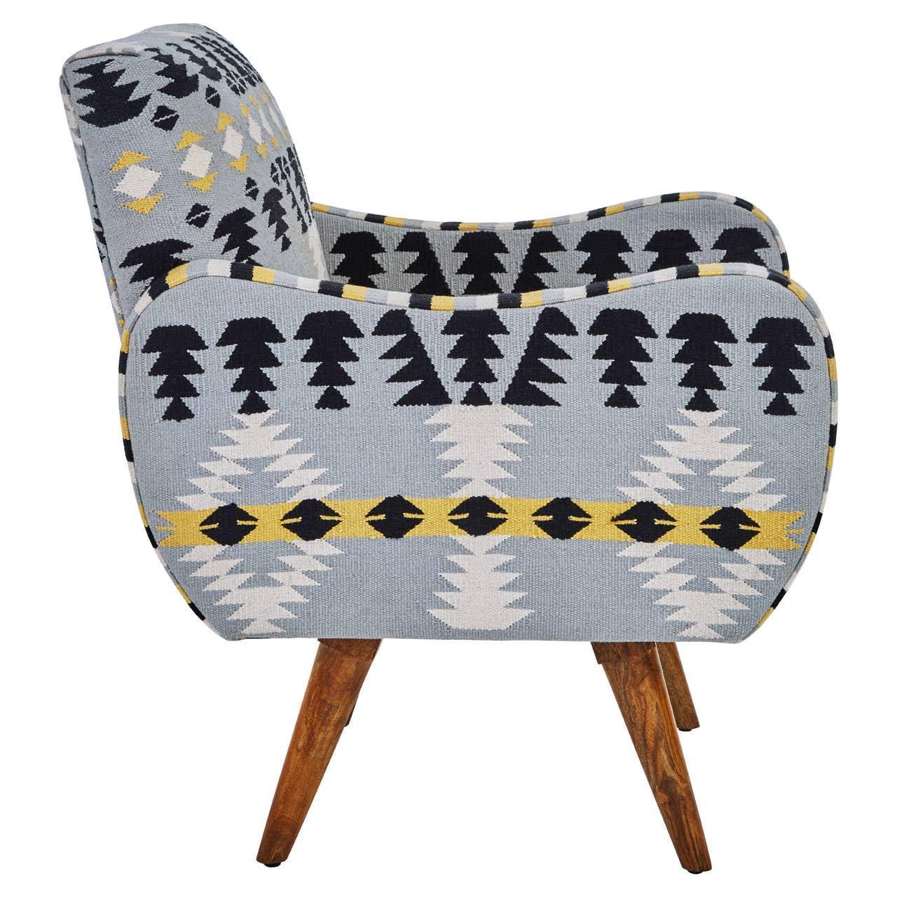 Patterned accent chair with blue, yellow, and white geometric fabric, side view, wood legs
