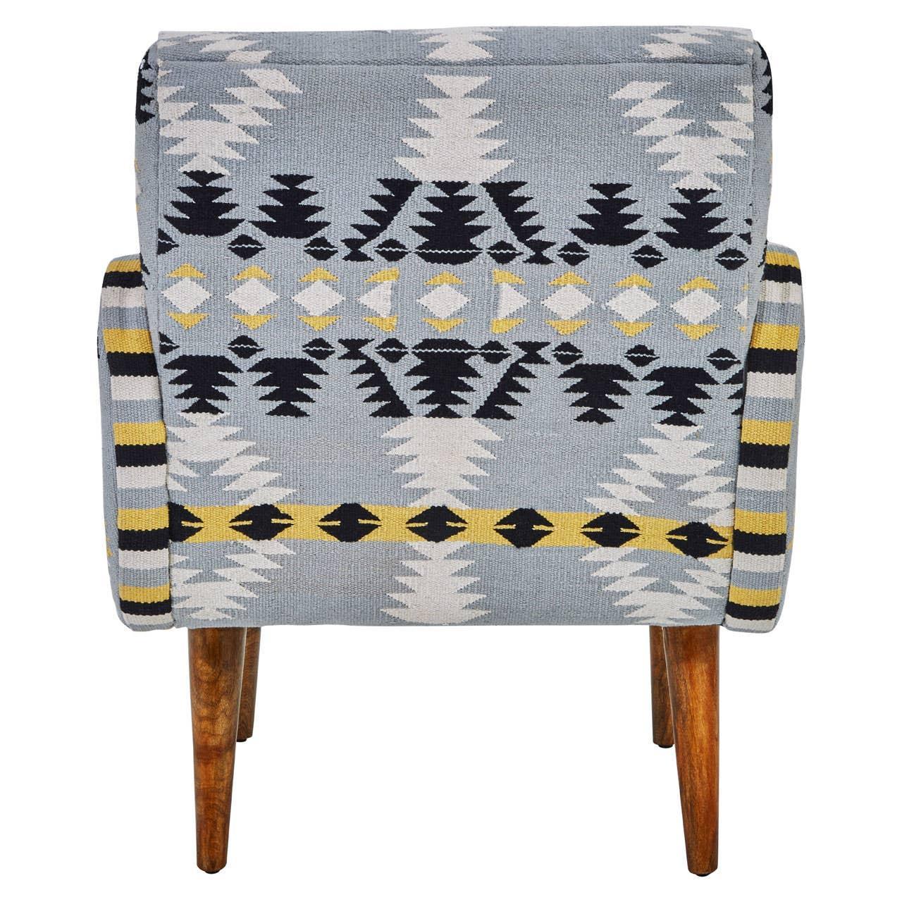 Patterned armchair with wooden legs and geometric blue, yellow, and black upholstery, rear view