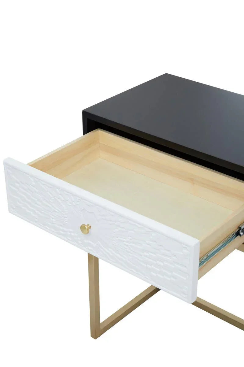 Modern bedside table with black top, white textured drawer front and gold metal legs
