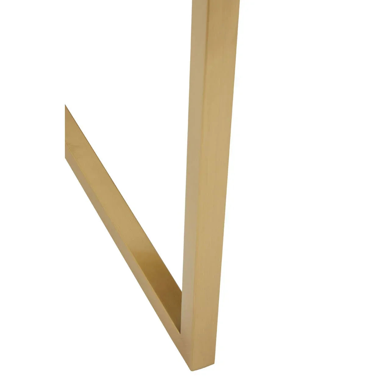 Closeup of gold metal table leg with modern angled design