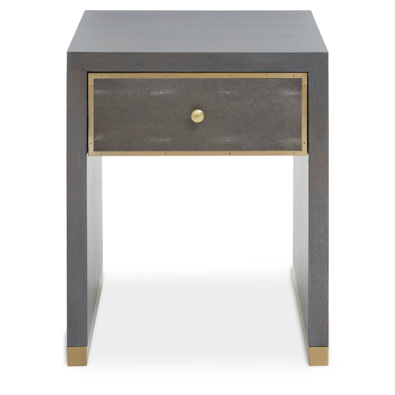 Grey wood bedside table with single drawer and brass trim, front view