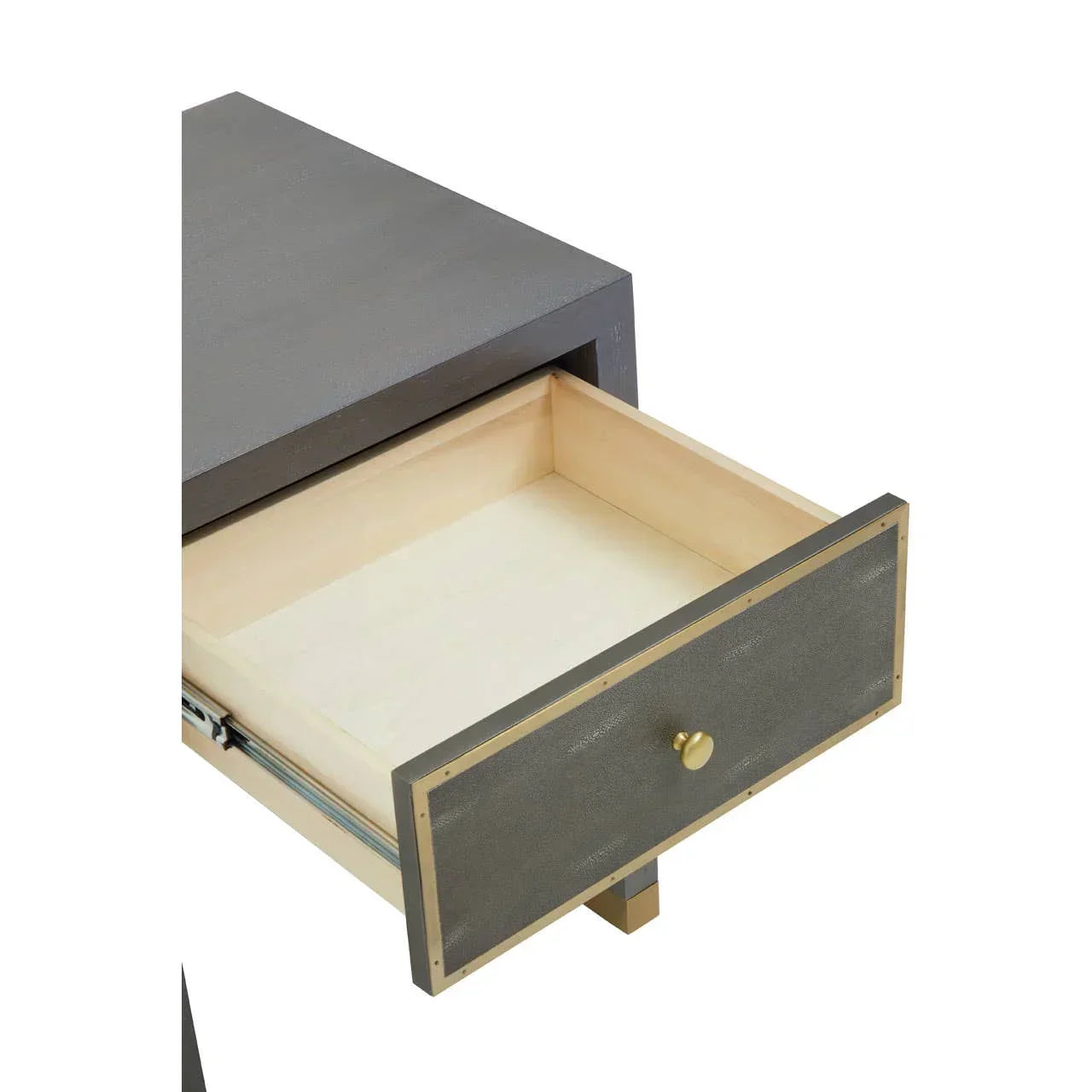 Closeup of modern bedside table with open drawer, textured grey front and gold handle