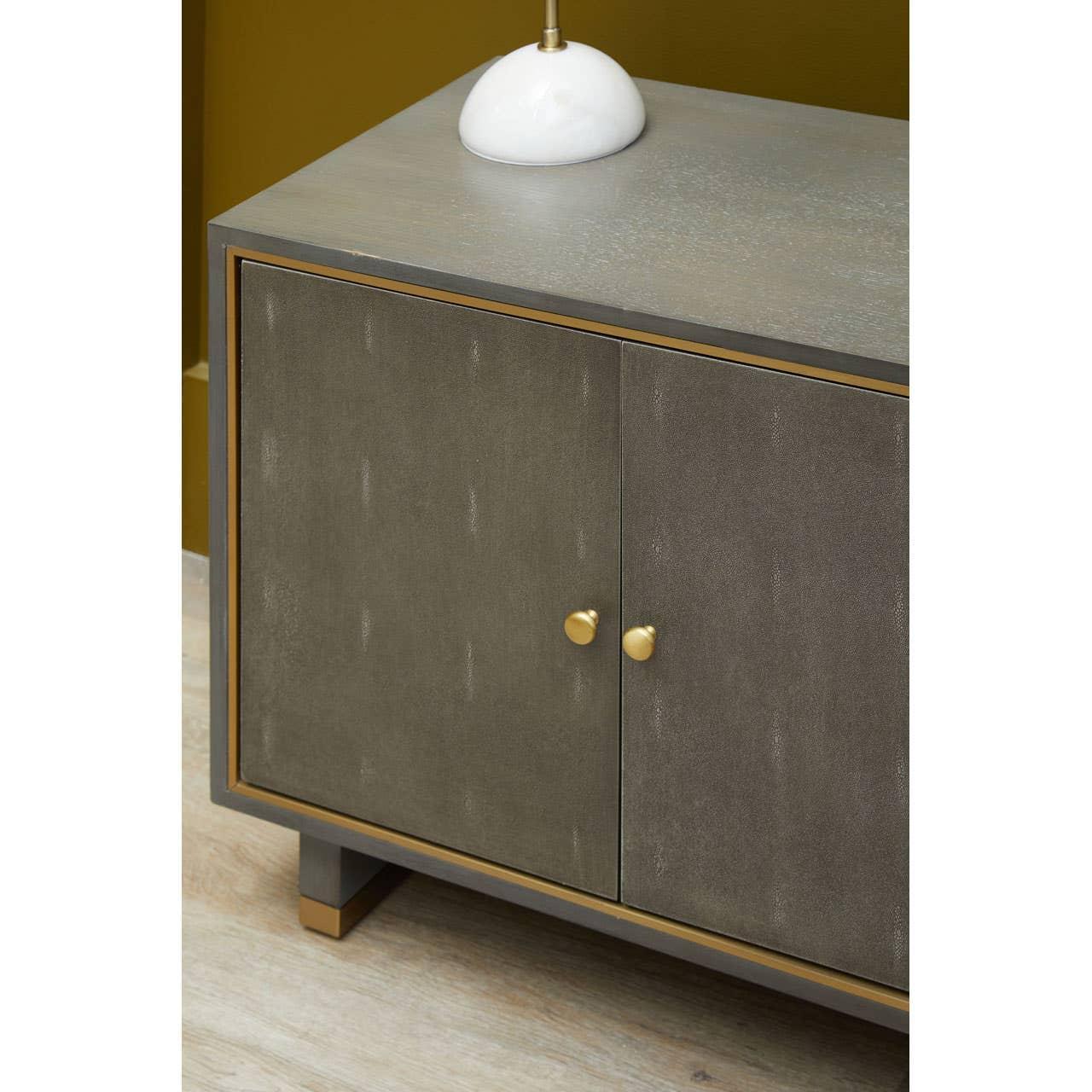 Modern sideboard with two grey doors, gold handles, and minimalist wood legs