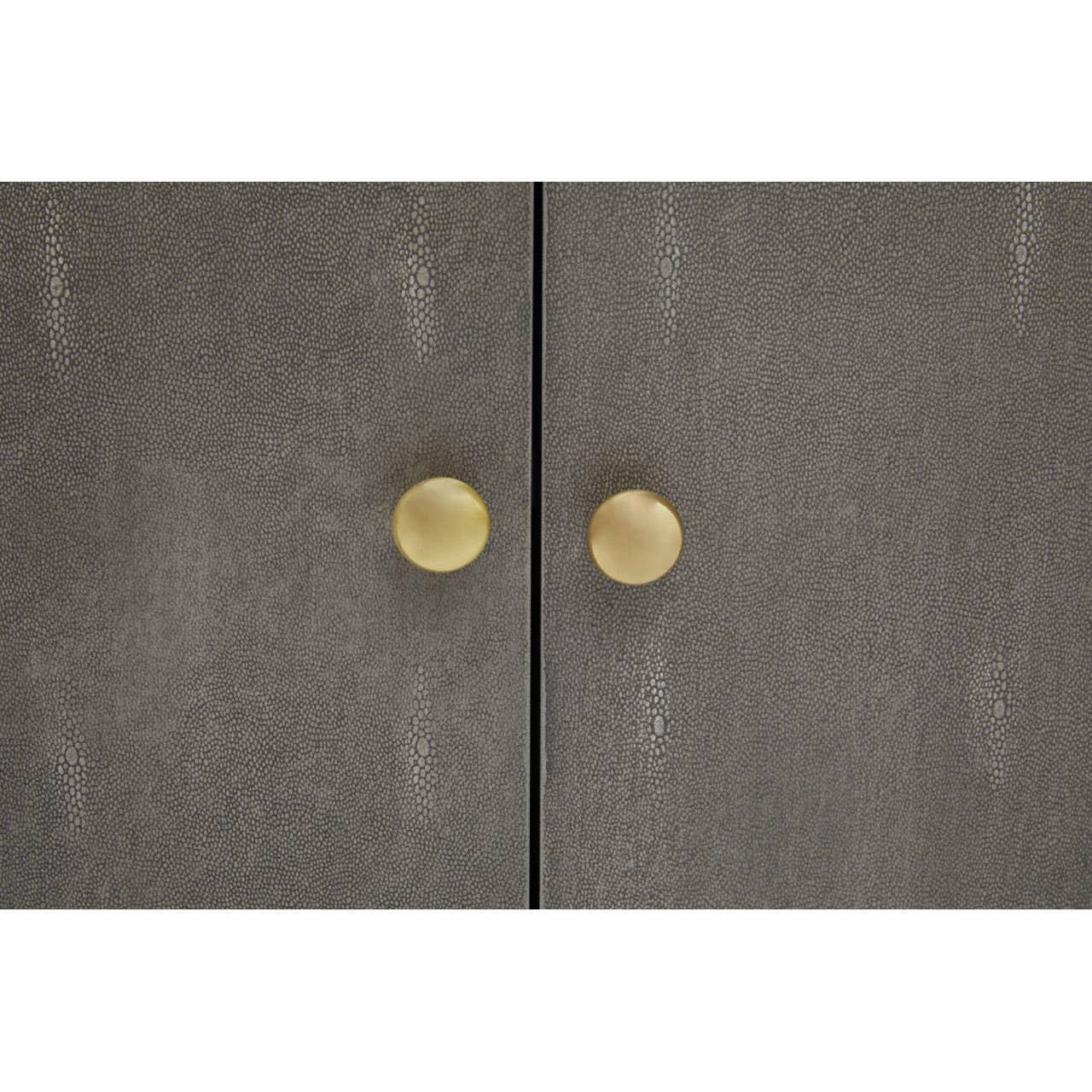 Textured grey cabinet doors with gold round handles, close-up furniture detail