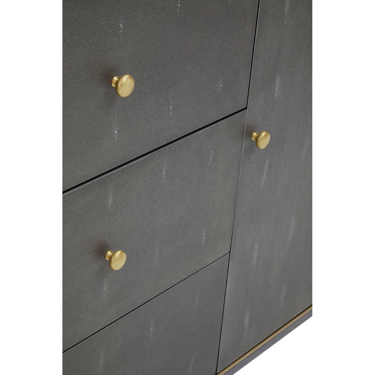 Grey cabinet drawers with gold metal knobs and textured wood finish
