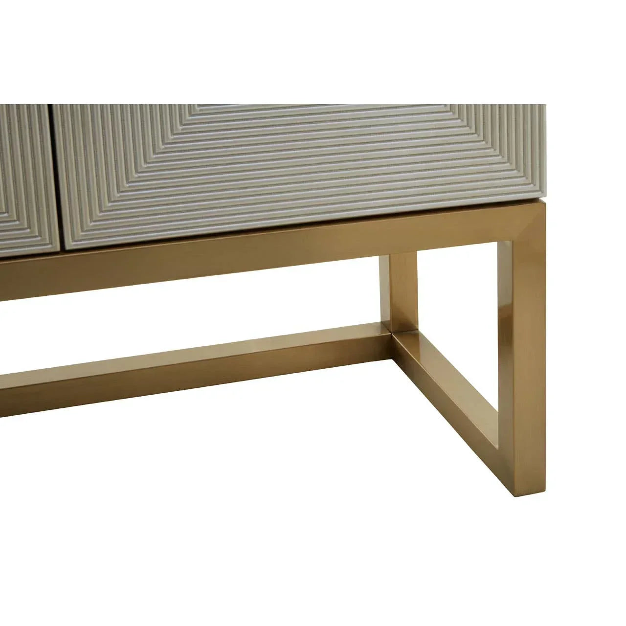 Close view of sideboard with gold metal base and textured geometric door pattern