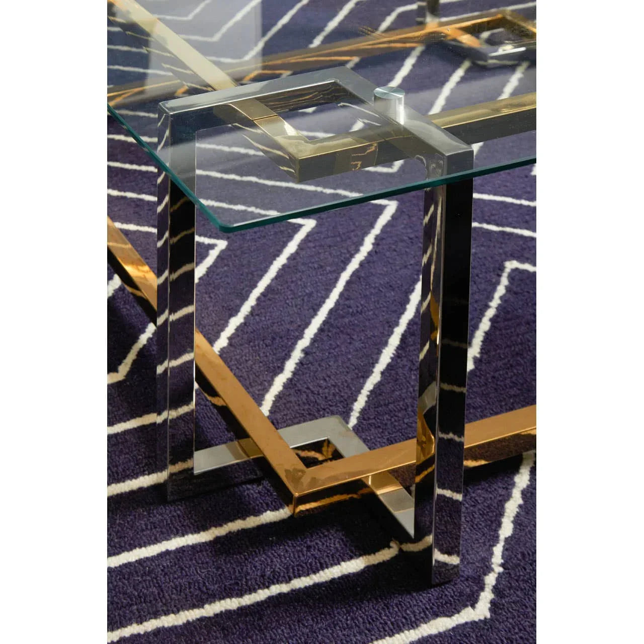 Glass coffee table with metal frame on purple geometric rug