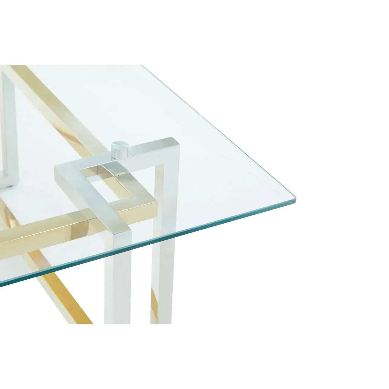 Glass top dining table with gold and chrome geometric metal legs, angled corner view