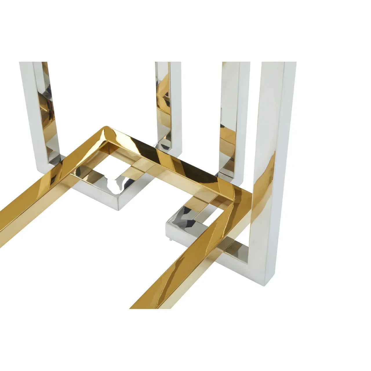 Chrome and gold metal table legs with geometric pattern, close-up view