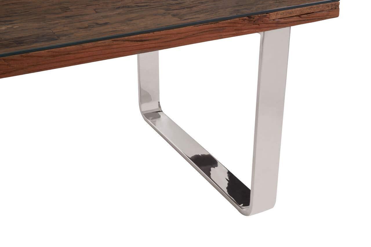 Wood and metal dining table corner with chrome leg and dark tabletop