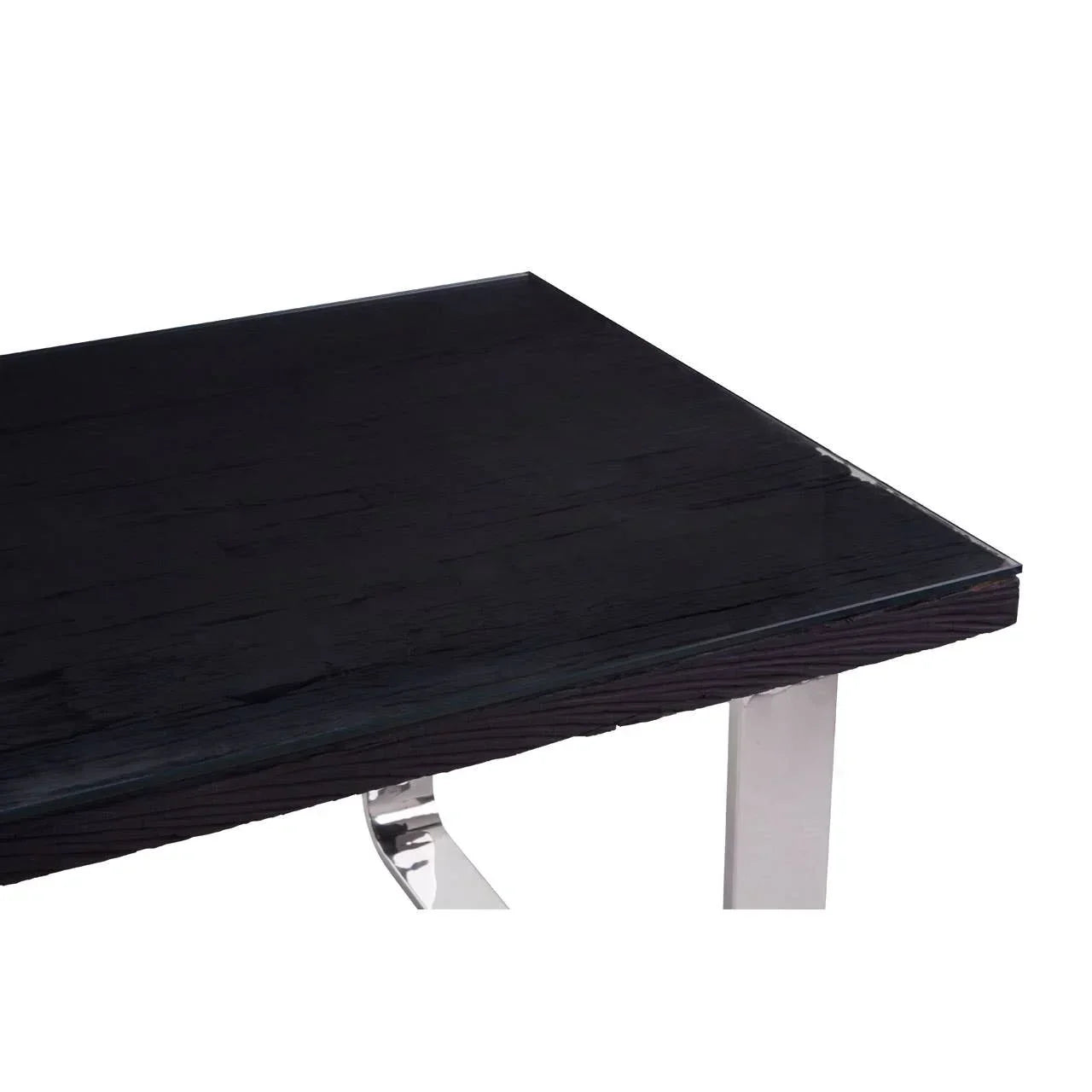 Black wood dining table corner with glass top and chrome metal leg