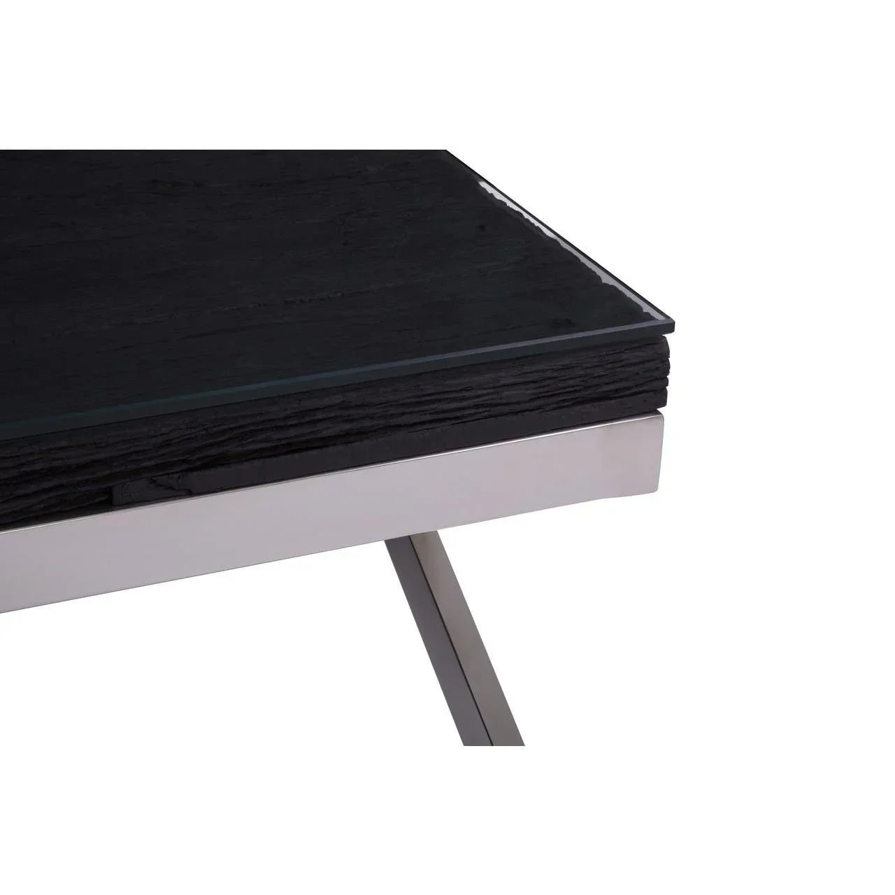 Close-up of modern dining table with black wood top, glass surface, and chrome legs