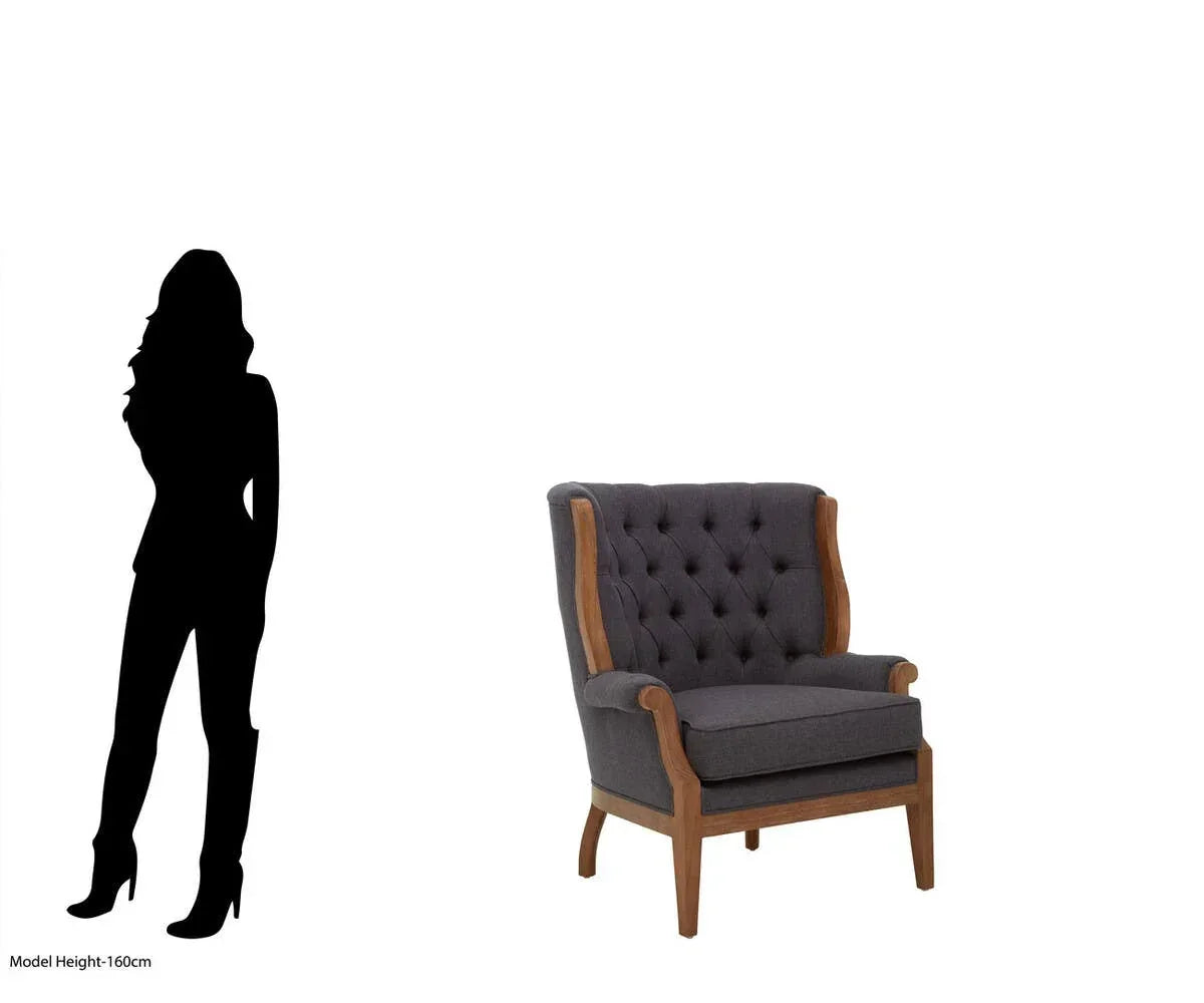 Charcoal fabric armchair with button tufting and wooden frame, size shown next to silhouette