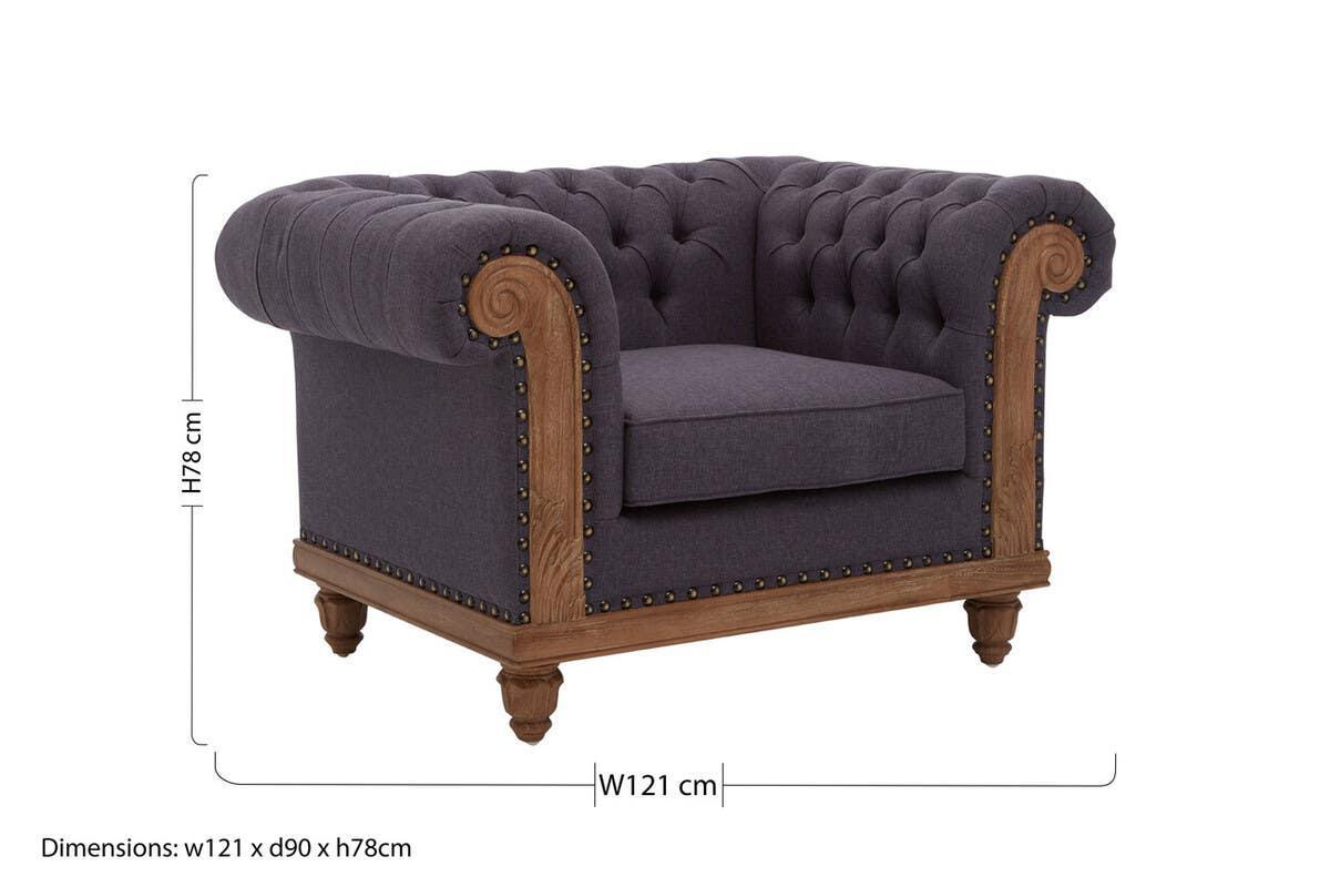 Dark grey upholstered armchair with deep button detail and wooden studded frame, 121 cm wide