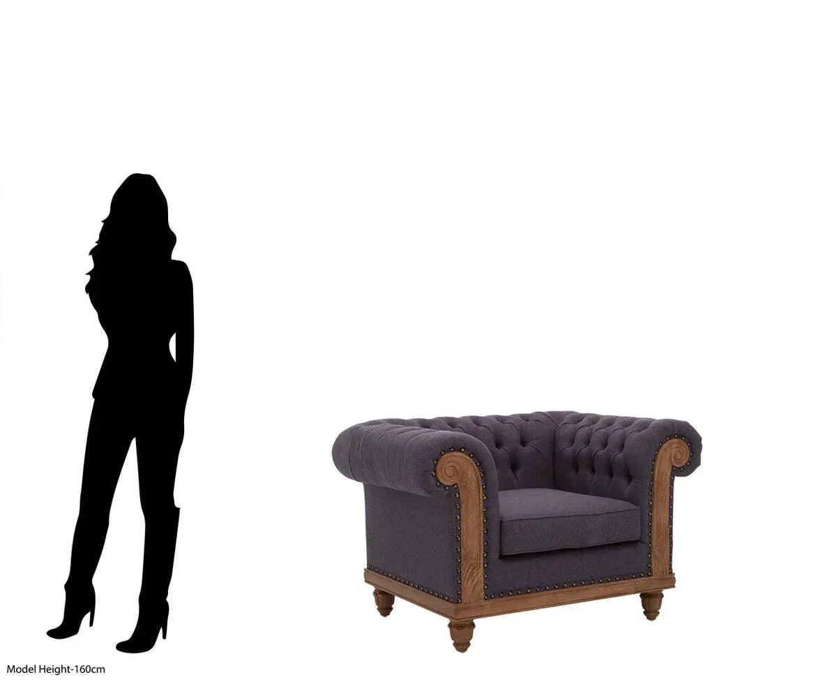 Grey Chesterfield armchair with button-tufted upholstery and wooden legs, size comparison
