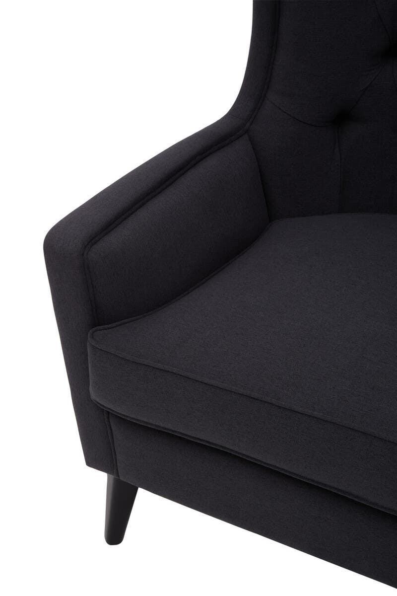 Black fabric armchair with cushioned seat and tapered wooden leg close-up