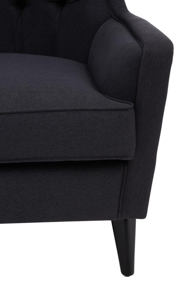 Close-up of dark grey fabric armchair with cushioned seat and tapered wooden leg