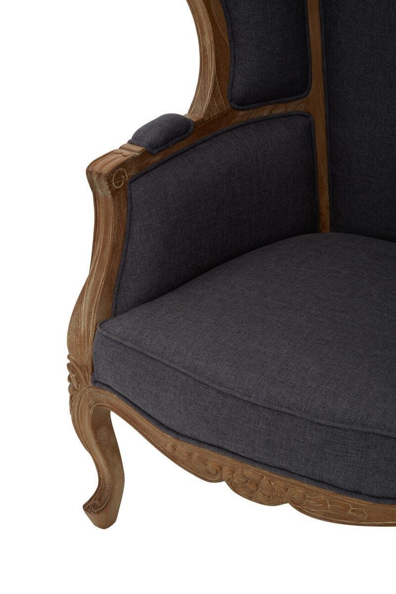 Dark grey upholstered armchair with carved wooden frame and curved legs, close-up view