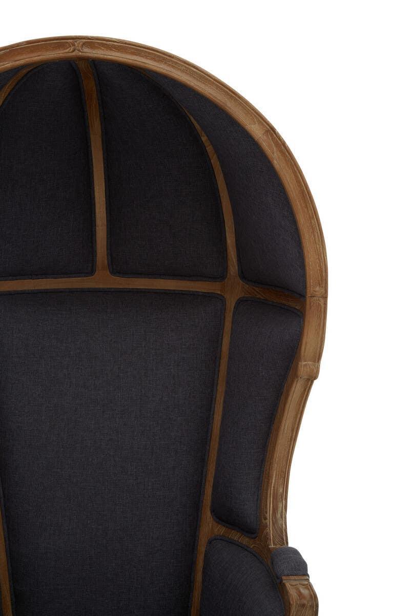 High back accent chair with dark upholstery and curved wood frame, partial front view
