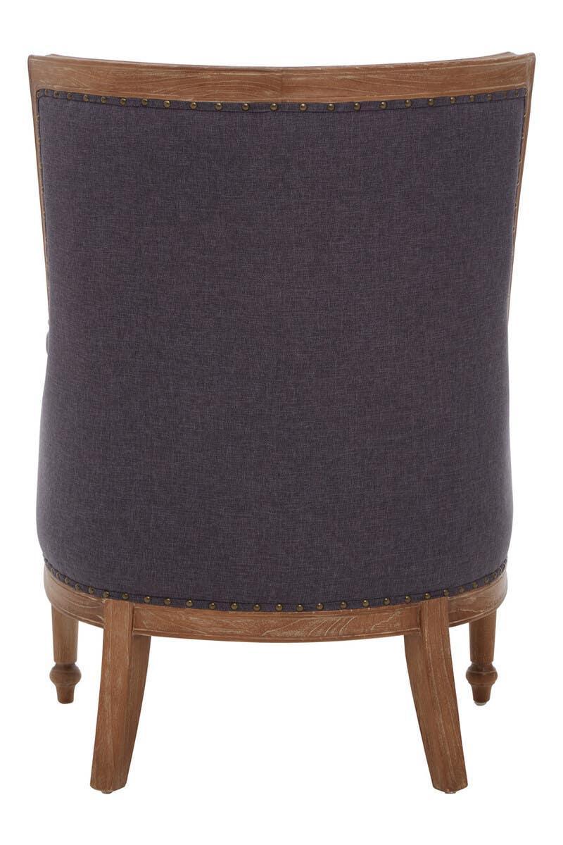 Back view of upholstered accent chair with wooden legs and nailhead trim