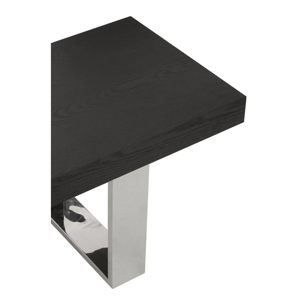 Black wood dining table with chrome metal leg, close-up of corner and surface texture