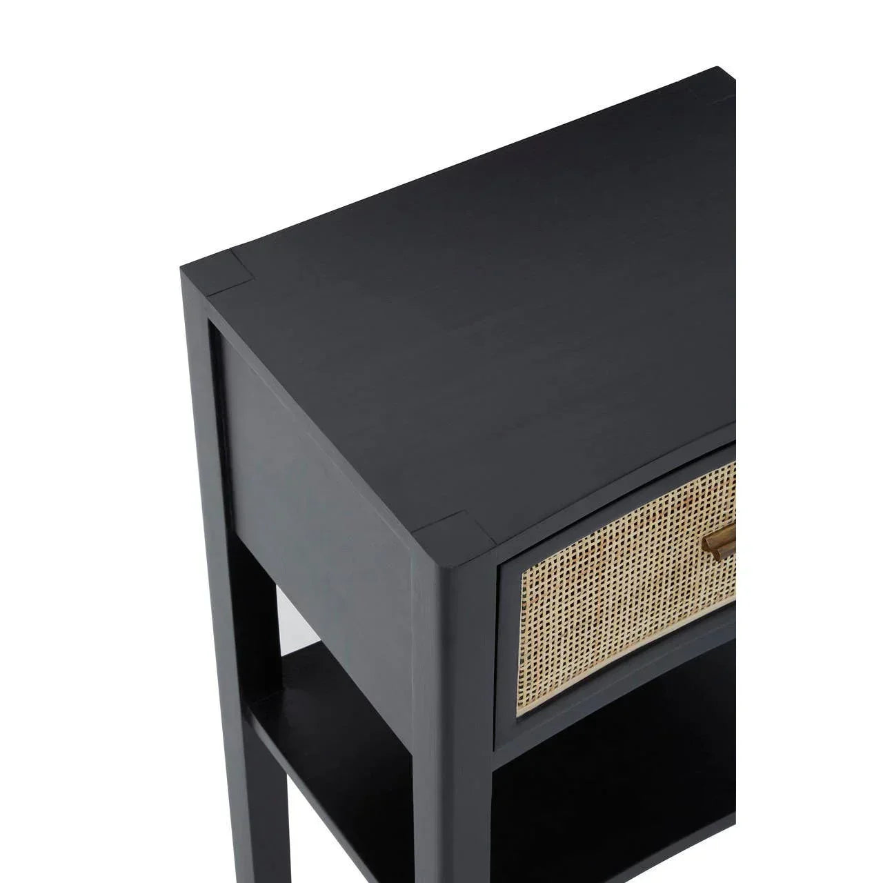 Black wood bedside table with rattan drawer front and brass handle, angled top view