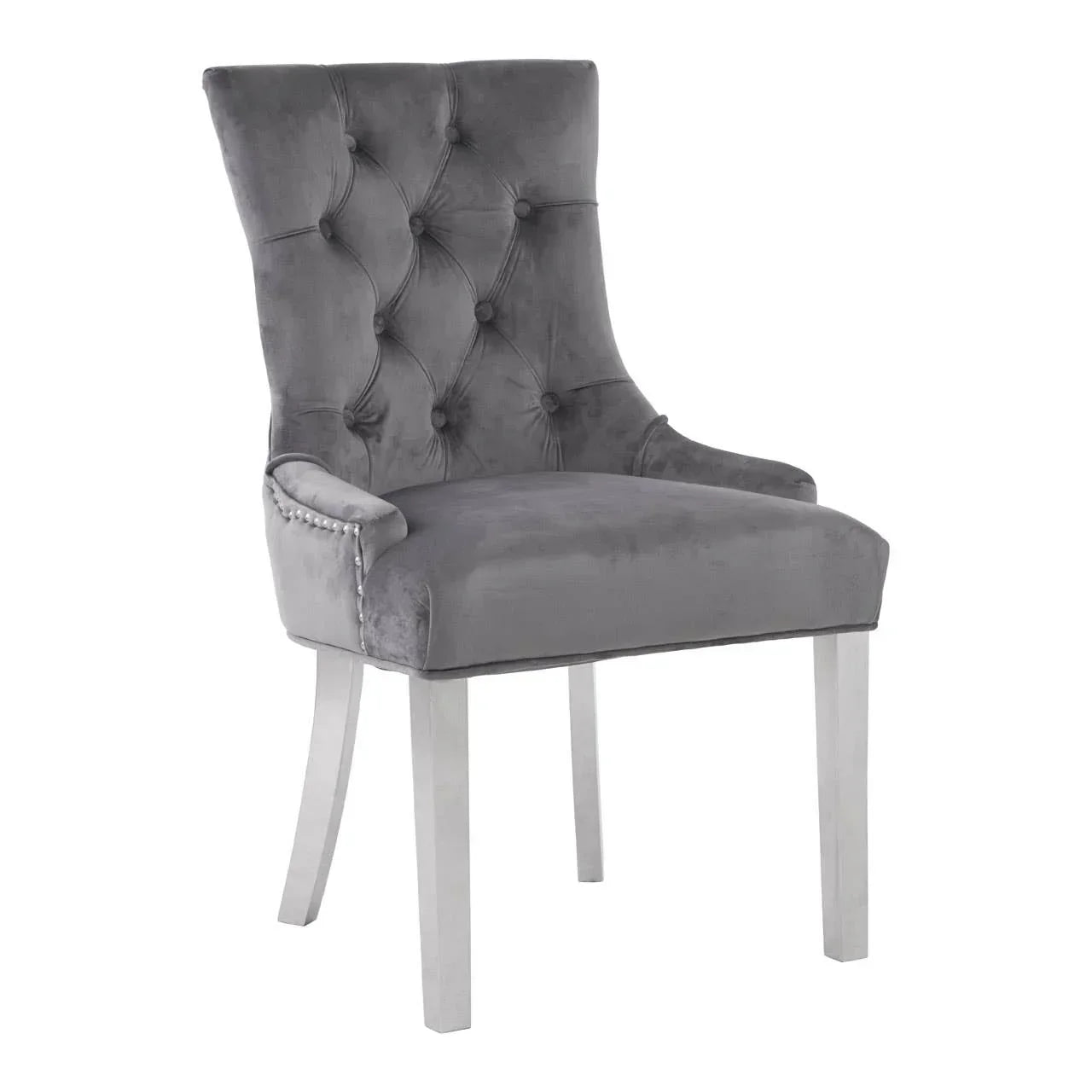 Grey velvet dining chair with button-tufted backrest and silver nailhead trim