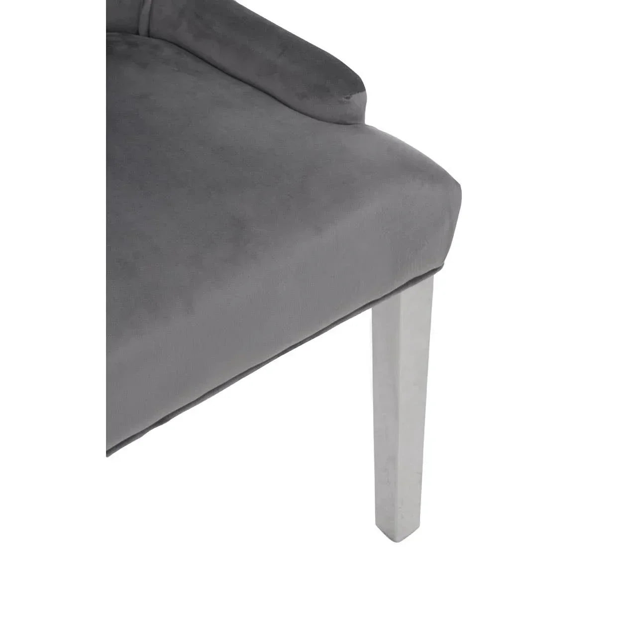Grey velvet dining chair seat with chrome metal leg close-up