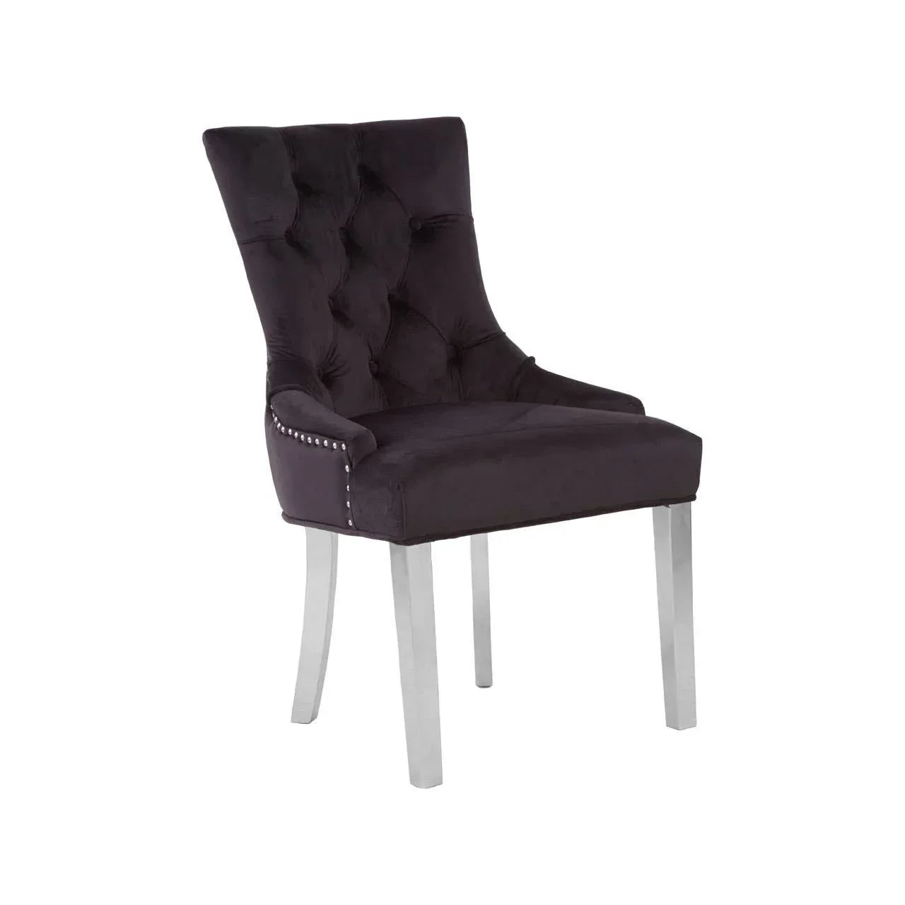 Black velvet dining chair with tufted back, silver stud trim, and chrome legs