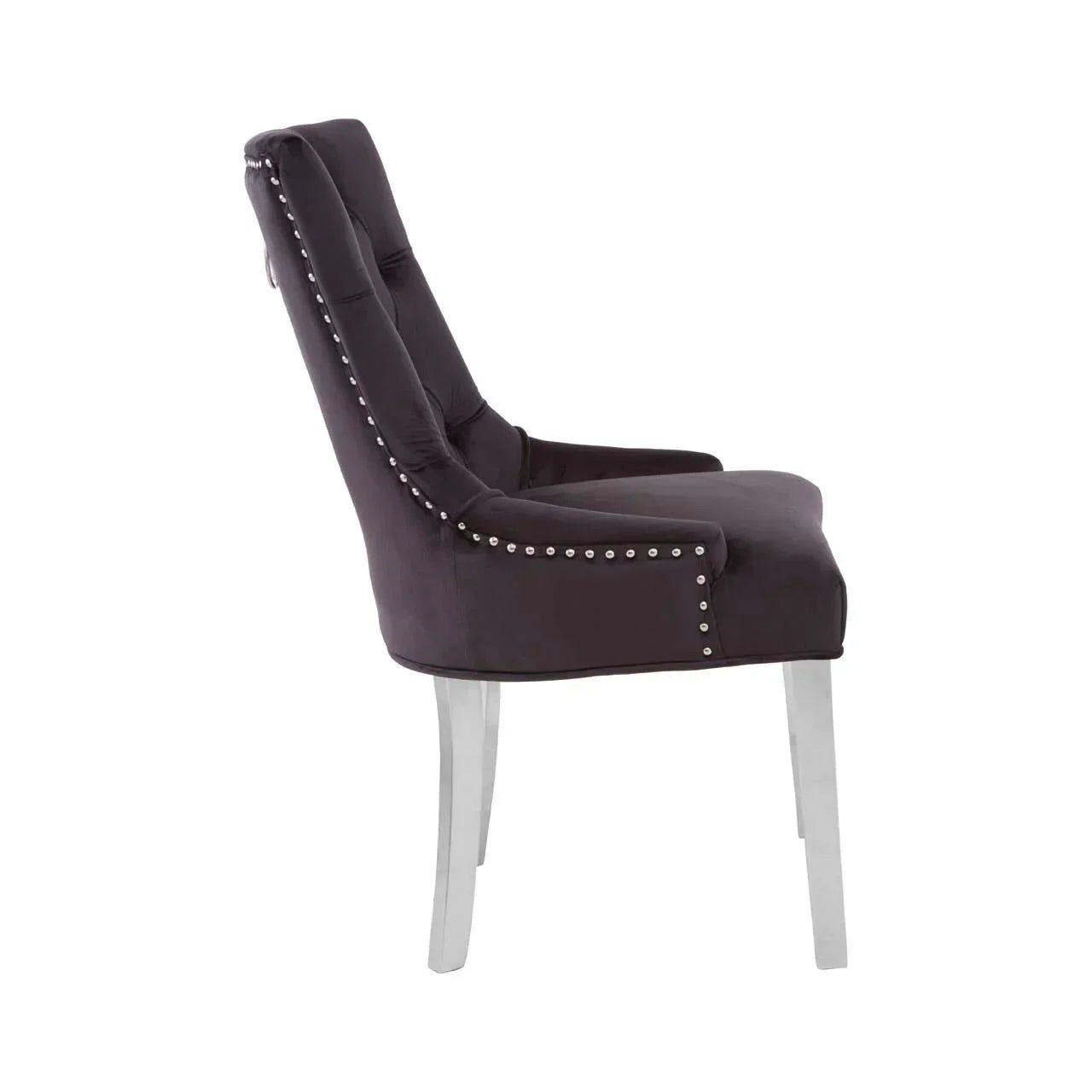 Side view of velvet dining chair with button tufting and silver stud detailing