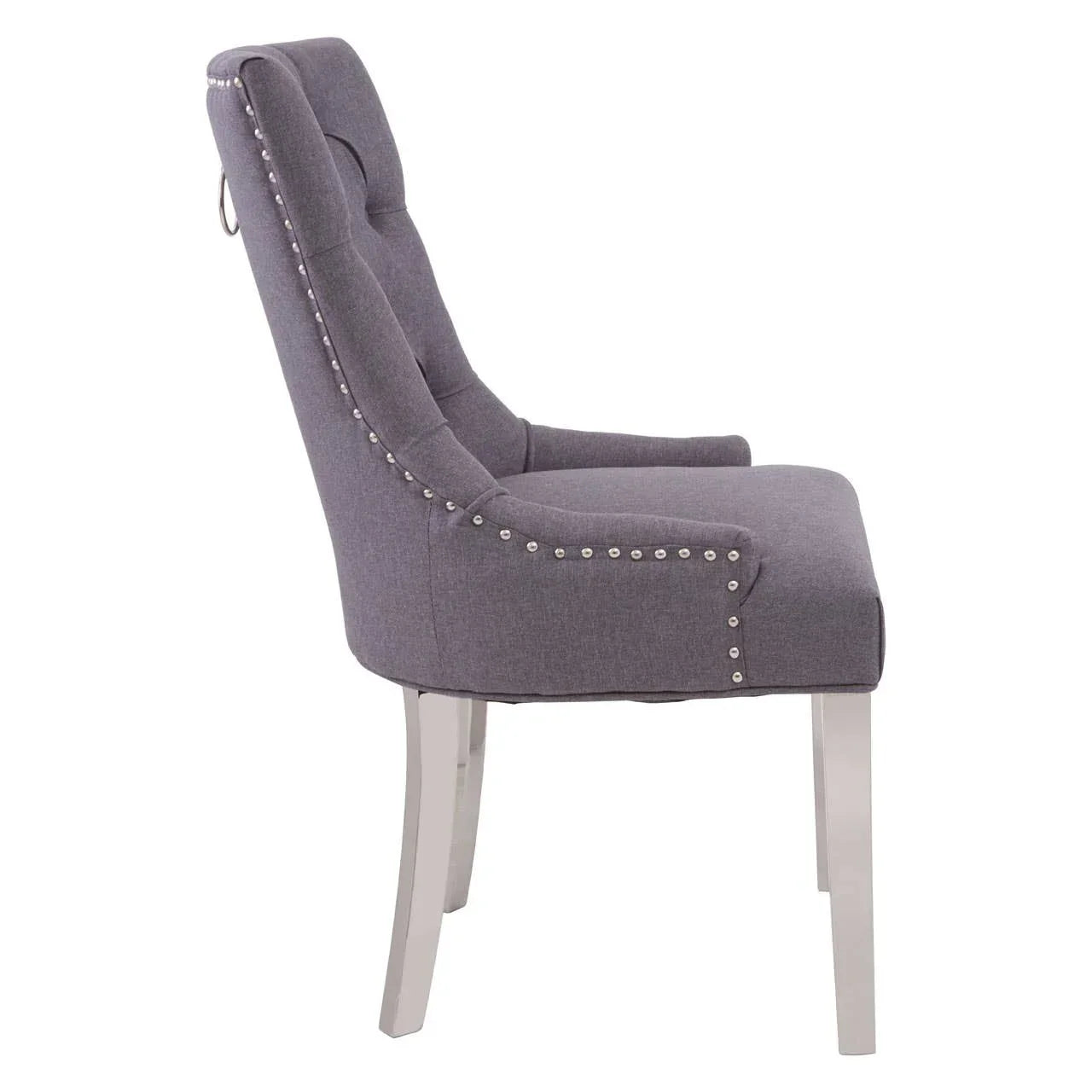 Grey upholstered dining chair with silver stud trim and chrome legs, side profile view