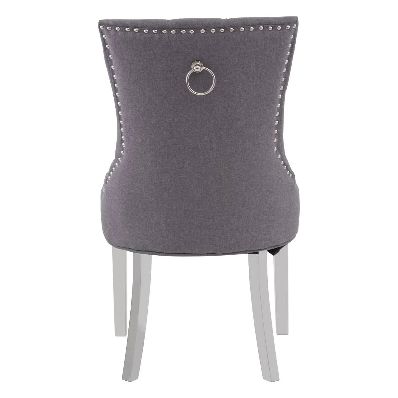 Grey upholstered dining chair with silver nailhead trim and chrome knocker back
