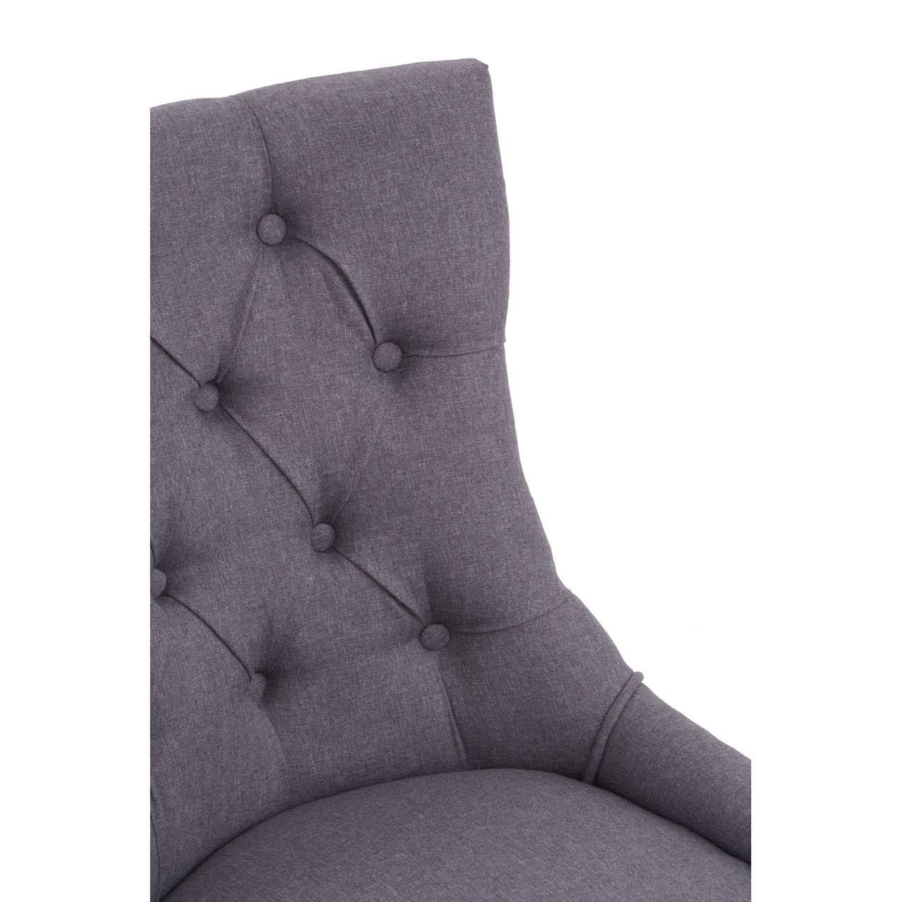 Close-up of grey fabric dining chair with button-tufted high backrest