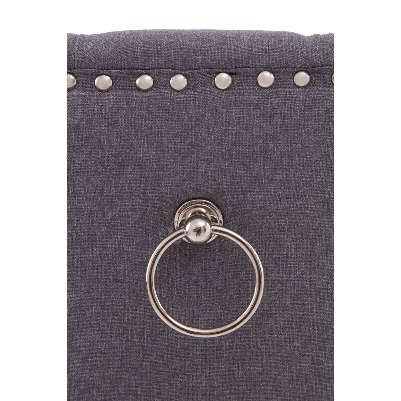 Grey dining chair backrest with silver stud trim and chrome knocker handle detail