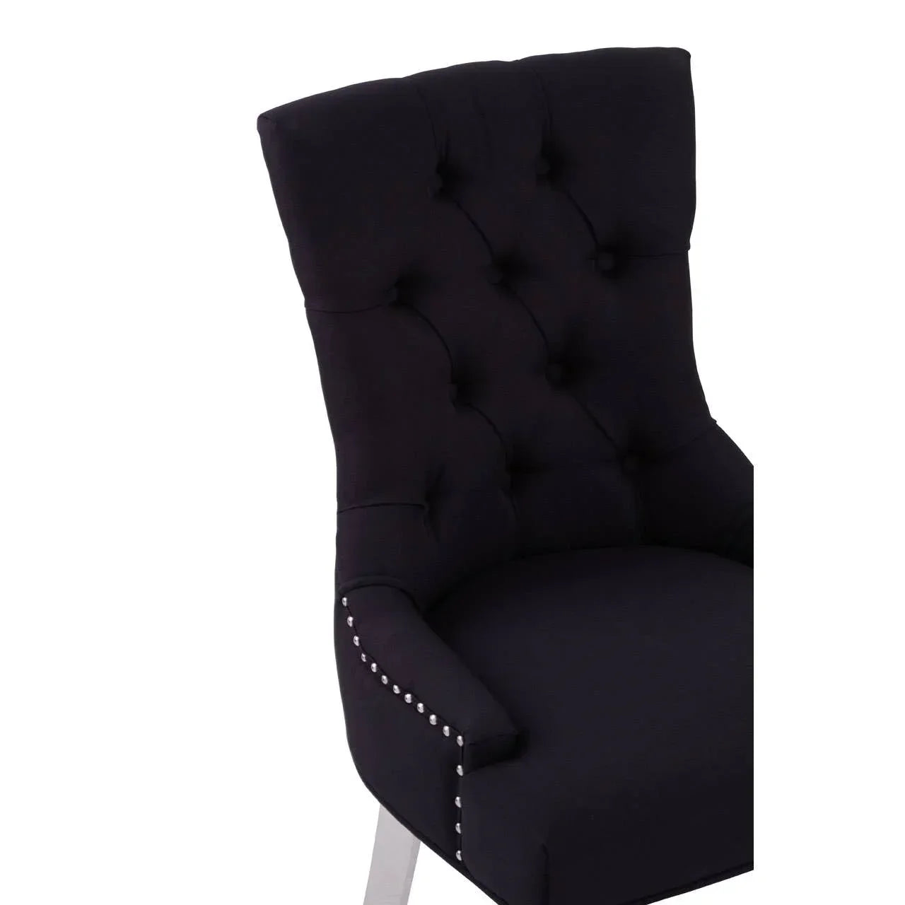 Black upholstered dining chair with button-tufted backrest and silver nailhead trim
