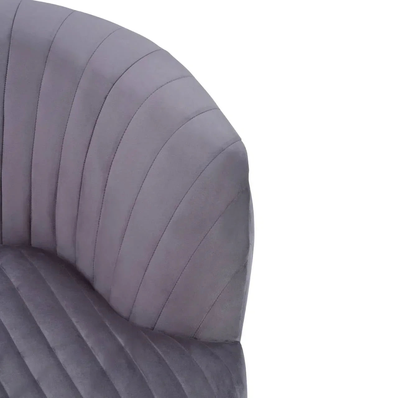 Closeup of grey velvet accent chair with curved, stitched backrest