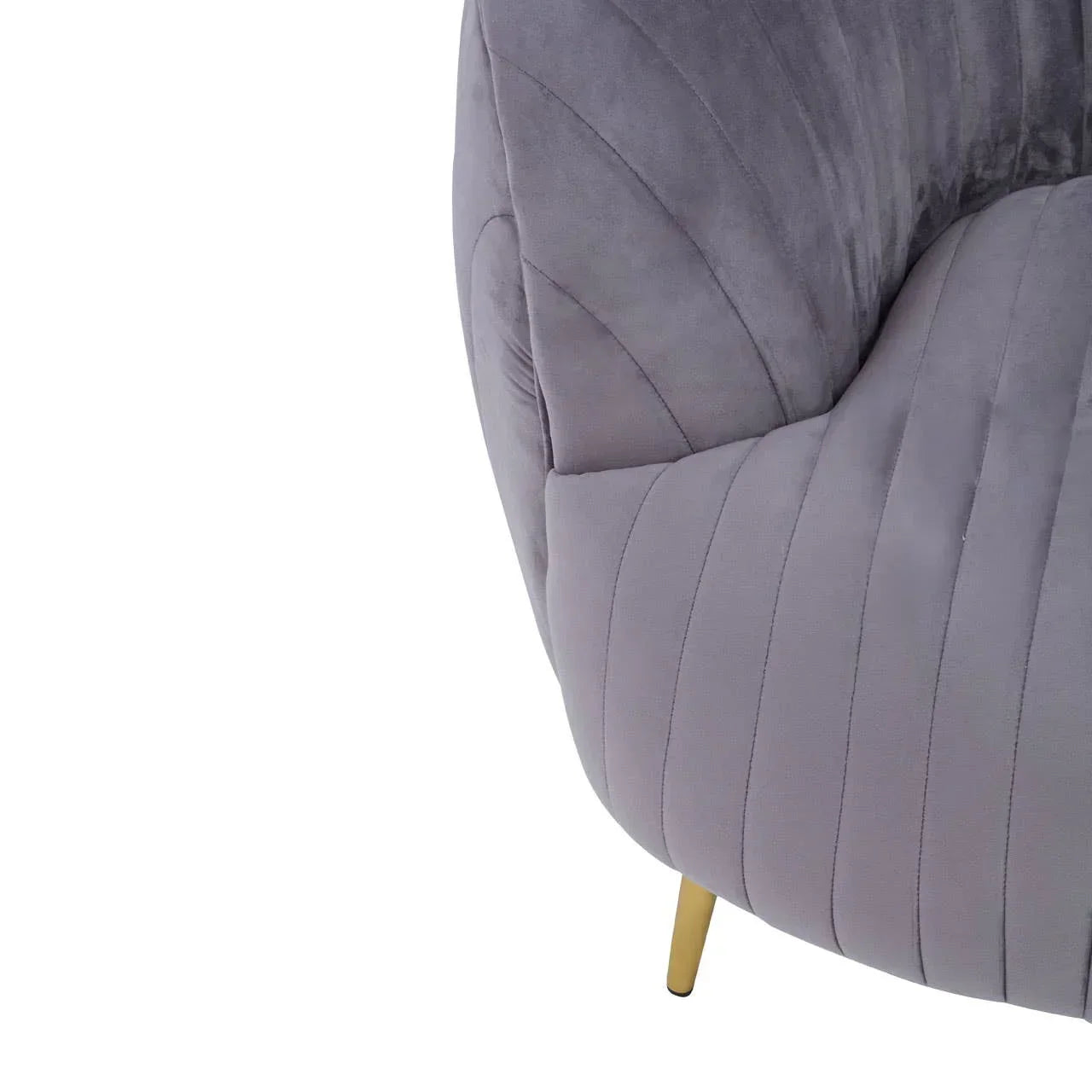 Grey fabric armchair with gold metal leg and stitched upholstery, close-up view
