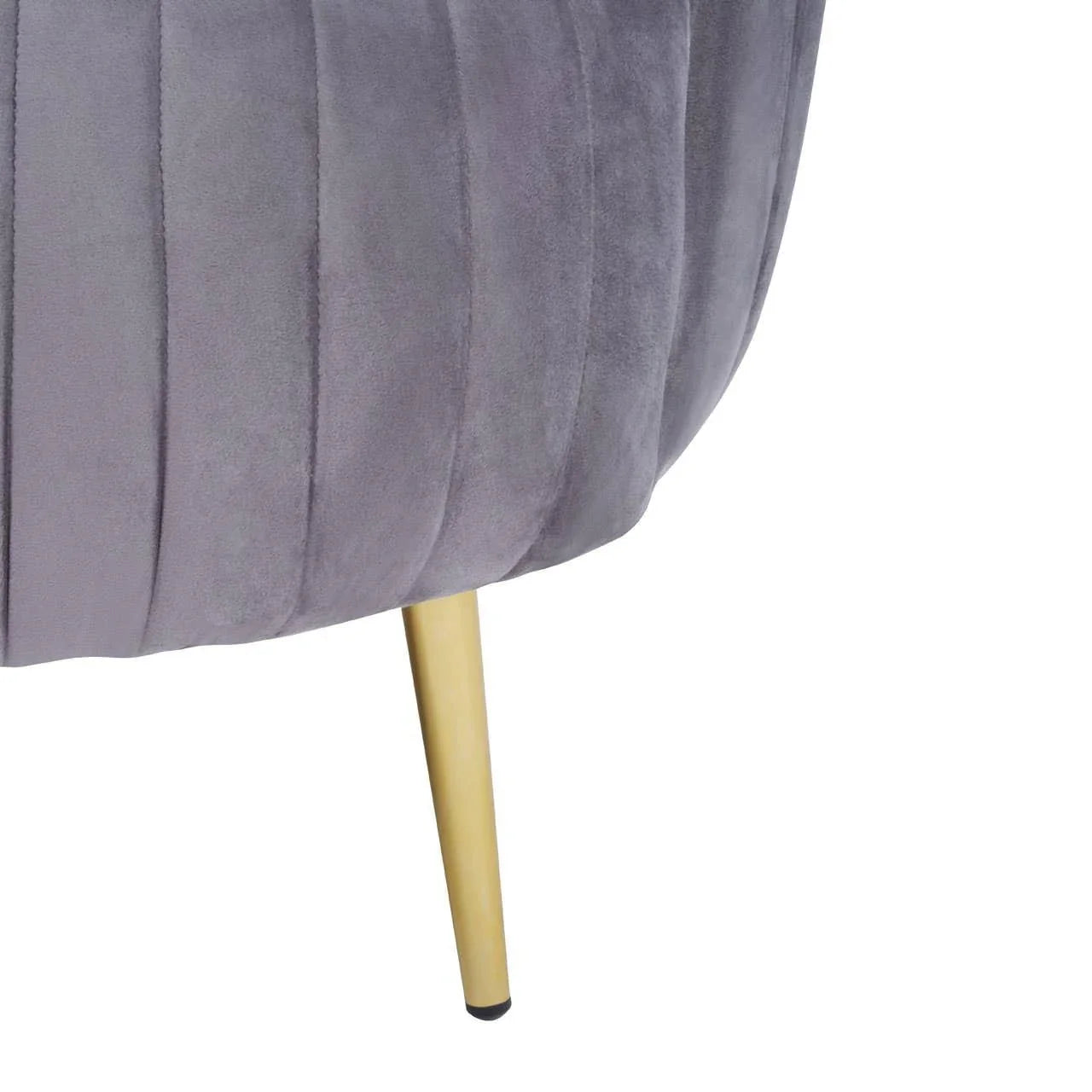 Grey velvet chair with gold metal leg and vertical stitched detail, close-up view