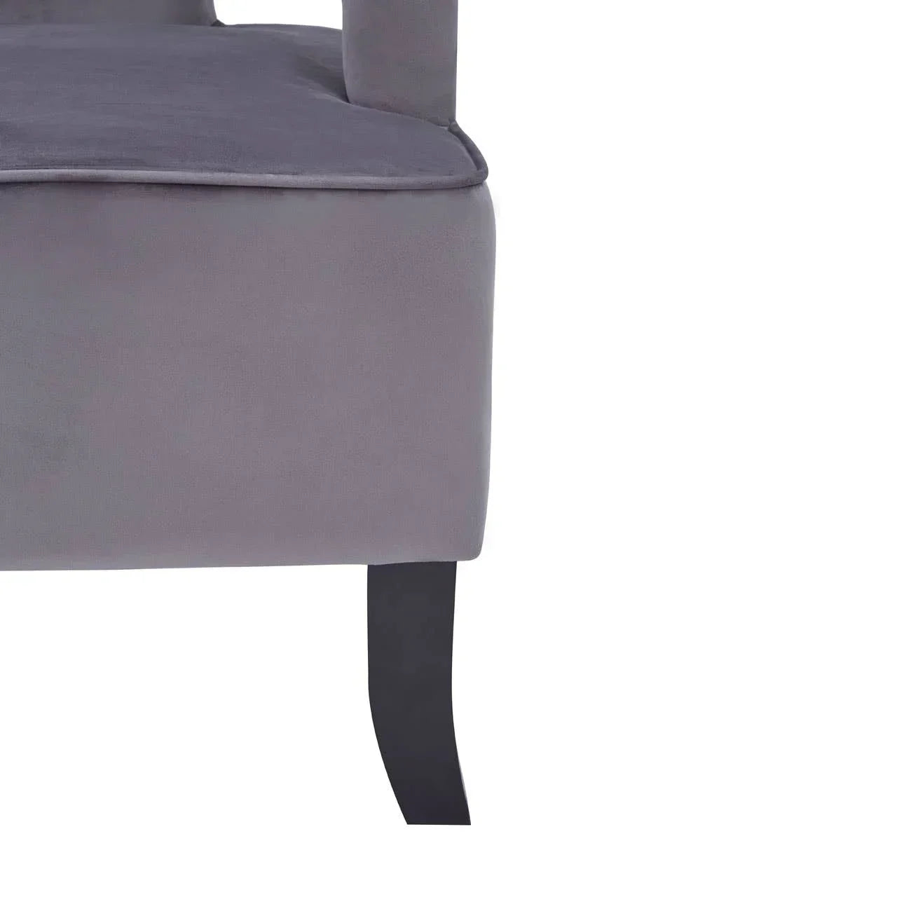 Grey velvet sofa corner with black wooden leg close-up