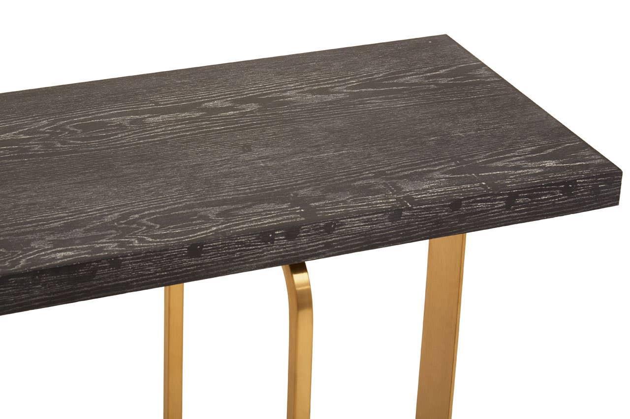 Black wood console table with gold metal legs, textured grain detail, angled view